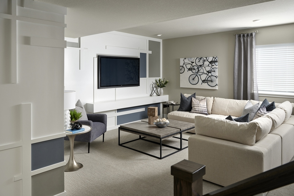 Interior view of a rec room option in Berkeley Homes' Painted Prairie Residence 2 plan, connecting to outdoor space via a roll-up garage door, from Eric Lucero Photography and NHTI.